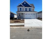 Charming two-story home featuring a two-car garage and manicured front yard at 609 Castle Ct., Myrtle Beach, SC 29579