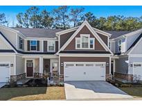 Charming two-story home with attached garage, neat landscaping, and a welcoming entrance at 115 Galil Dr. # B, Myrtle Beach, SC 29579