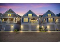 Charming coastal homes showcase covered garages and spacious balconies under a beautiful twilight sky at 138 Marblehead Dr., Little River, SC 29566