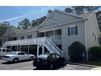 Two story condo featuring stairs, white railings, neutral siding, and parking in front at 160 Lazy Willow Ln. # 204, Myrtle Beach, SC 29577