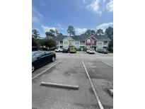 Well-maintained multi-Gathering homes featuring ample parking spaces and mature trees at 1719 Low Country Pl. # B, Myrtle Beach, SC 29577