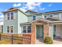 Charming townhome with a brick entryway, light teal siding, black railing and a well-maintained landscape at 1749 Culbertson Ave. # 1749, Myrtle Beach, SC 29577