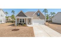 Charming single-Gathering home featuring a well-manicured lawn and an attached two-car garage at 197 Astoria Park Loop, Conway, SC 29526