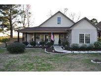 Charming home with stone and wood exterior, covered porch, and landscaped front yard at 1991 Highway 9 W, Longs, SC 29568