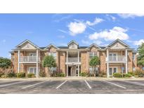 Charming condo building with brick facade, white balconies, and well-maintained landscaping at 2061 Silvercrest Dr. # 7E, Myrtle Beach, SC 29579