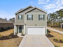 Charming two-story home with a two-car garage, neutral siding, and green shutters at 283 Marauder Dr., Longs, SC 29568