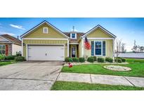 Charming home featuring a well-maintained lawn, inviting curb appeal, and an attached two-car garage at 300 Lorenzo Dr., North Myrtle Beach, SC 29582