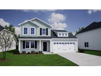 Charming two-story home with a two-car garage, manicured lawn, and inviting curb appeal at 304 Dunlin Pl, Conway, SC 29526