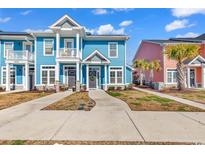 Charming two-story blue townhome with a quaint balcony and welcoming front entrance at 3534 Pampas Dr. # 505, Myrtle Beach, SC 29577