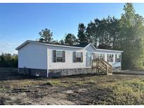 Charming single-story home with white siding, black shutters, and a stone foundation at 3685 Nichols Hwy., Aynor, SC 29511