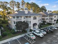 Condo complex featuring classic architecture, and a well-maintained parking lot at 4222 Pinehurst Dr. # I-9, Little River, SC 29566