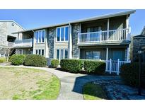 Charming condo building featuring white trim, brick accents, and well-maintained landscaping at 4717 Cobblestone Ln. # B3, Myrtle Beach, SC 29577