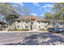 Inviting two-story condo building featuring charming stairs and well-maintained landscaping with ample parking space at 491 Ocean Creek Dr. # 2613, Myrtle Beach, SC 29572