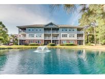Beautiful multi-story condo building on a scenic pond with manicured landscaping at 5825 Catalina Dr. # 531, North Myrtle Beach, SC 29582