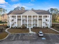 Attractive three-story condo with white columns, multiple balconies and ample parking at 5834 Longwood Dr. # 303, Murrells Inlet, SC 29576