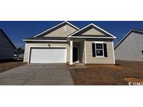 Charming single-story home featuring a white garage door, and neutral colored siding at 657 Castillo Dr., Loris, SC 29569