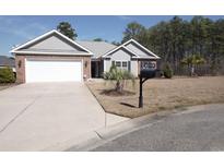 Charming single-story home featuring gray siding, an attached garage, and a well-manicured front lawn at 1005 Lynches River Ct., Myrtle Beach, SC 29588