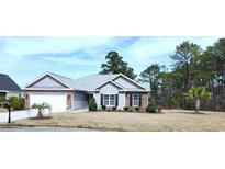 Charming single-story home with brick accents, attached garage, and manicured landscaping at 1005 Lynches River Ct., Myrtle Beach, SC 29588