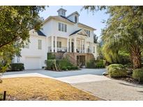 Stunning white home with a grand front porch, manicured landscaping, and a large driveway at 1046 Wallace Pate Dr., Georgetown, SC 29440