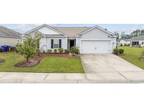 Charming single-story home with a well-manicured lawn and a two-car attached garage at 1320 Midtown Village Dr., Conway, SC 29526