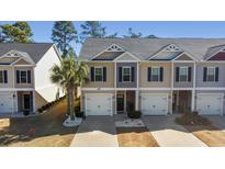 Inviting townhome featuring neutral-toned siding, black shutters, and well-manicured landscaping with a palm tree at 1487 Lanterns Rest Rd. # 4, Myrtle Beach, SC 29579