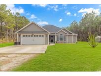 Charming one-story home featuring a well-manicured lawn, two car garage, and classic exterior at 1930 W Homewood Rd., Conway, SC 29526