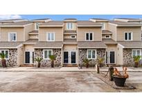 Charming townhomes featuring stone accents, shingle siding, and well-maintained landscaping at 2010 Sand Dunes Dr. # 204, Myrtle Beach, SC 29577