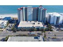 Stunning aerial view of beachfront condominium complex with parking, palm trees, and ocean backdrop at 2401 S Ocean Blvd. # 971, Myrtle Beach, SC 29577