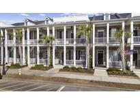 Charming townhomes feature brick facade, white columns, and private balconies with palm tree landscaping at 2794 Howard Ave. # D, Myrtle Beach, SC 29577