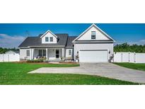 Charming two-story home with an attached two-car garage, inviting front porch, and well-manicured lawn at 3995 Highway 905, Conway, SC 29526