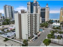 Condo building exterior featuring a pool, parking, and beach view in a coastal setting at 400 20Th Ave. N # 1101, Myrtle Beach, SC 29577