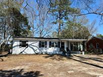 Charming single-story home featuring a welcoming porch and a well-maintained front yard at 512 W Baptist St., Marion, SC 29571