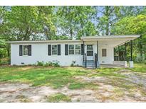 Charming single-story home featuring a covered porch and well-maintained front yard at 512 W Baptist St., Marion, SC 29571