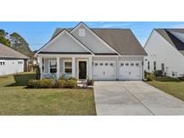 Charming single-Gathering home with a well-manicured lawn and an attached two-car garage at 617 Cherry Blossom Dr., Murrells Inlet, SC 29576
