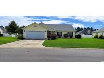 Charming single story home with a well manicured front lawn and attached garage at 724 Alexis Dr., Longs, SC 29568