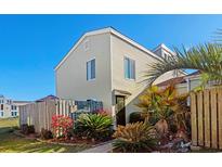 Charming home exterior featuring a well-manicured lawn and tropical landscaping at 800 9Th Ave. S # R-3, North Myrtle Beach, SC 29582