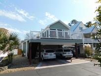 Two-story coastal home with a charming exterior and convenient under-house parking at 829 9Th Ave. S, North Myrtle Beach, SC 29582