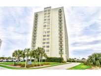 A high-rise condo building featuring private balconies and lush tropical landscaping at 9820 Queensway Blvd. # 301, Myrtle Beach, SC 29572