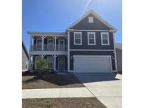 Charming two-story home featuring a welcoming front porch, two-car garage, and a beautifully landscaped yard at 1324 Safe Haven Dr., Myrtle Beach, SC 29579