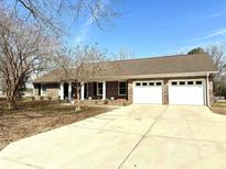 Charming brick home featuring a two-car garage and well-manicured landscaping at 1663 Little Buck Rd., Conway, SC 29526