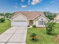 Charming single-story home featuring a two-car garage, well-maintained lawn, and inviting curb appeal at 286 Bonnie Bridge Circle, Myrtle Beach, SC 29579