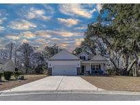 Charming single-Gathering home with a well-manicured lawn and inviting front porch at 29 Bird Watch Ct., Georgetown, SC 29440