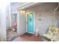 Charming condo featuring a vibrant turquoise front door and decorative exterior accents at 312 73Rd Ave. N # 15, Myrtle Beach, SC 29572