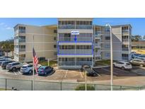 Exterior shot of a condo building featuring screened-in balconies and on-site parking at 4350 Intercoastal Dr. # 2207, Little River, SC 29566
