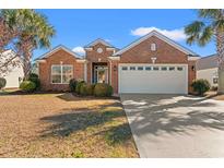 Charming red brick home with a well-manicured lawn and a two-car garage at 4517 Planters Row Way, Myrtle Beach, SC 29579