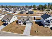Expansive aerial view of a charming home with a two-car garage nestled in a lovely residential community at 459 Honeyhill Loop, Conway, SC 29526