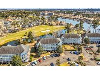 Scenic aerial view of condo community with golf course, lakes, and ample parking at 699 Riverwalk Dr. # 202, Myrtle Beach, SC 29579