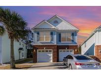 Charming two-story home with a two-car garage and a well-manicured lawn at 1341 Brown Pelican Dr., Myrtle Beach, SC 29577