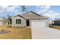 Charming one-story home features neutral siding, attached garage, and manicured lawn at 1451 Porchfield Dr., Conway, SC 29526