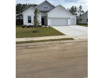 Charming single-Gathering home featuring a three-car garage and a well-manicured front yard at 179 Glengrove Lane, Murrells Inlet, SC 29576